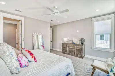 a bedroom with a bed and a ceiling fan at Daydream Believer (Seagrove) in Santa Rosa Beach