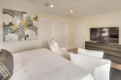 a bedroom with a bed and a flat screen tv at Seas the Day in Santa Rosa Beach