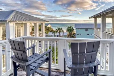 two chairs on a balcony with a view of the ocean at Seas the Day in Santa Rosa Beach
