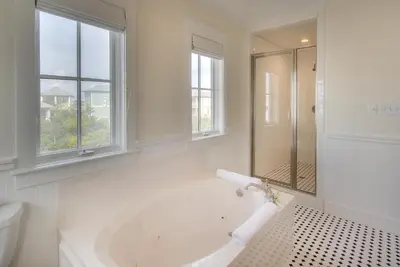 a white bathroom with a tub and a toilet at Seas the Day in Santa Rosa Beach