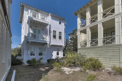 a white building with balconies on the side of it at Seas the Day in Santa Rosa Beach