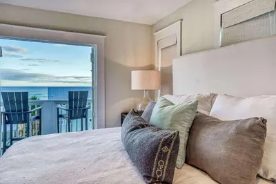 a bedroom with a bed and a large window at Seas the Day in Santa Rosa Beach