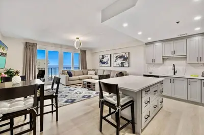 a kitchen and living room with a table and chairs at Spectacular 1BD Resort Condo! Amazing Gulf Views! Free Beach Chairs! by Dolce Vita Getaways PCB in Panama City Beach