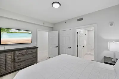 a bedroom with a bed and a flat screen tv at Spectacular 1BD Resort Condo! Amazing Gulf Views! Free Beach Chairs! by Dolce Vita Getaways PCB in Panama City Beach