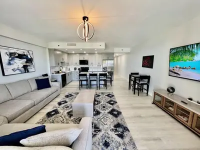 a large living room with a couch and a kitchen at Spectacular 1BD Resort Condo! Amazing Gulf Views! Free Beach Chairs! by Dolce Vita Getaways PCB in Panama City Beach