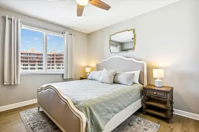 a bedroom with a bed with a mirror and a window at Shores of Panama 2028 - Luxurious Gulf-Front 3 Bedroom 3 Bath Sleeps 10 condo in Panama City Beach