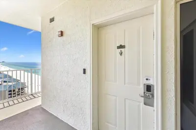 a door to a balcony with a view of the ocean at Shores of Panama 2028 - Luxurious Gulf-Front 3 Bedroom 3 Bath Sleeps 10 condo in Panama City Beach
