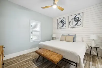 a bedroom with a bed and a ceiling fan at Laketown Wharf #137 by Nautical Properties in Panama City Beach