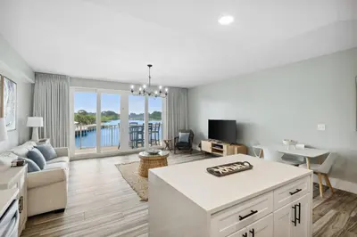 a living room with a couch and a table at Laketown Wharf #137 by Nautical Properties in Panama City Beach