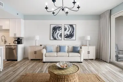 a living room with a couch and a table at Laketown Wharf #137 by Nautical Properties in Panama City Beach