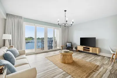 a living room with a couch and a tv at Laketown Wharf #137 by Nautical Properties in Panama City Beach
