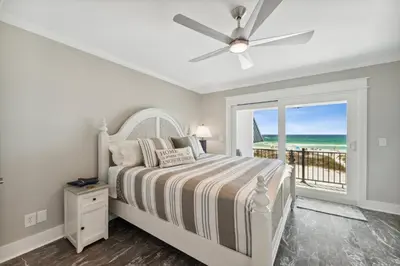 a bedroom with a bed and a ceiling fan at Dolphin View at 8629 Surf Drive by Nautical Properties in Panama City Beach