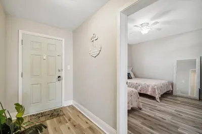 a room with a door and a bedroom with a bed at Blissful Sunset at Laketown Wharf #1312 by Nautical Properties in Panama City Beach