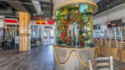 a large colorful vase sitting on a stand in a room at Laketown Wharf #1319 by Nautical Properties in Panama City Beach