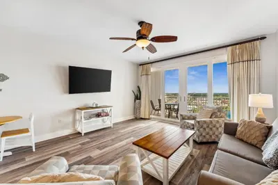 a living room with a couch and a tv at The Beach Is Calling at Laketown Wharf #1329 at Nautical Properties in Panama City Beach