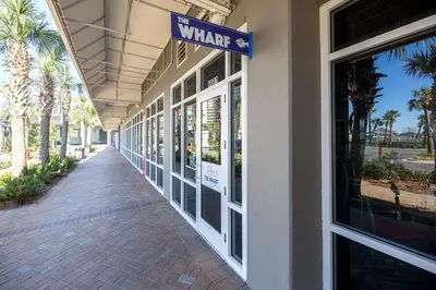 a walkway outside of a building with a sign on it at The Beach Is Calling at Laketown Wharf #1329 at Nautical Properties in Panama City Beach