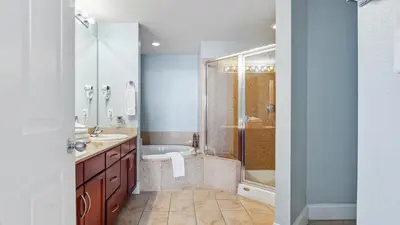 a bathroom with a tub and a sink and a shower at Nautical Breeze at Laketown Wharf #1911 by Nautical Properties in Panama City Beach