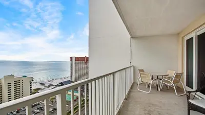 a balcony with a table and chairs and the ocean at Nautical Breeze at Laketown Wharf #1911 by Nautical Properties in Panama City Beach