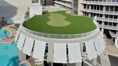 an aerial view of a building with a golf course on the lawn at Nautical Breeze at Laketown Wharf #1911 by Nautical Properties in Panama City Beach