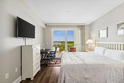 a bedroom with a bed and a flat screen tv at Laketown Wharf #638 by Nautical Properties in Panama City Beach