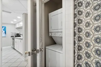 a kitchen with a washer and dryer at Moondrifter #208 by Nautical Properties in Panama City Beach
