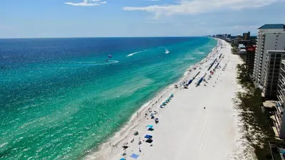 an overhead view of a beach with people and the ocean at Nautical Watch #D4 by Nautical Properties in Panama City Beach