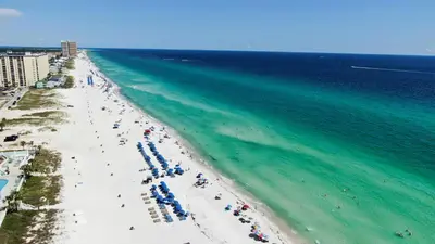 an overhead view of a beach with people and the ocean at Nautical Watch #D4 by Nautical Properties in Panama City Beach