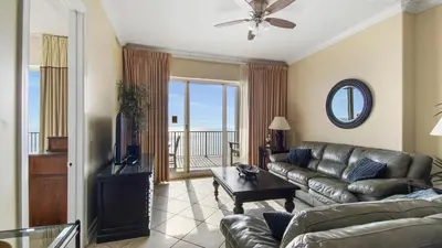 a living room with a couch and a television at Ocean Reef #2109 by Nautical Properties in Panama City Beach