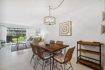 a dining room with a table and chairs at Sea Side Villas 118 by InJoy Vacations in Panama City Beach