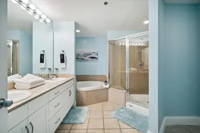 a bathroom with two sinks and a shower at Laketown Wharf #828 by Nautical Properties in Panama City Beach