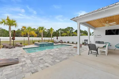 a backyard with a swimming pool and a pavilion at Beach House - Sugary Sands by Panhandle Getaways in Panama City Beach