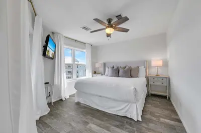 a white bedroom with a bed and a ceiling fan at Beachside Villas 933 in Santa Rosa Beach
