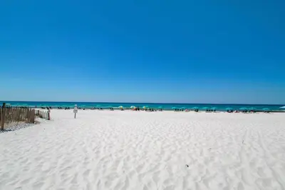 a white beach with a bunch of people on it at Beachside Villas 933 in Santa Rosa Beach