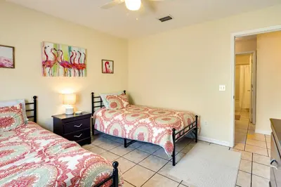 a bedroom with two beds and a lamp on a table at Panama City Vacation Rental with 2 Community Pools! in Panama City Beach