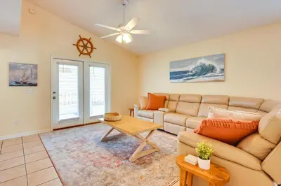a living room with a couch and a table at Panama City Vacation Rental with 2 Community Pools! in Panama City Beach
