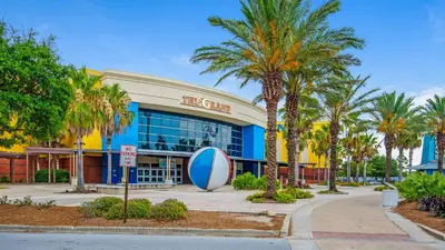 a shopping center with palm trees in front of it at A Salty Cru in Panama City Beach