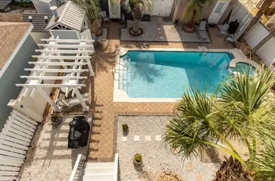 an overhead view of a swimming pool with white stairs at Sea La Vie in Panama City Beach