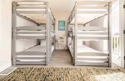 a hallway with four bunk beds in a room at Sea La Vie in Panama City Beach