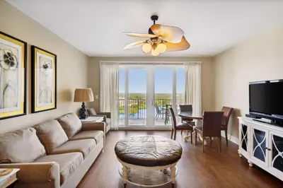 a living room with a couch and a ceiling fan at Laketown Wharf #1230 by Nautical Properties Vacation Rentals in Panama City Beach