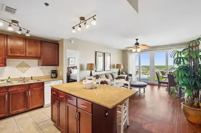 an open kitchen and living room with a dining room at Laketown Wharf #1230 by Nautical Properties Vacation Rentals in Panama City Beach