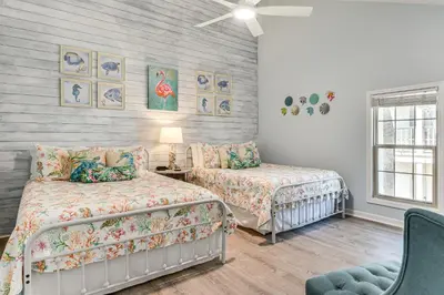 a bedroom with two beds and a chair at Walk to Beach! PCB Resort Condo with Pool Access in Panama City Beach