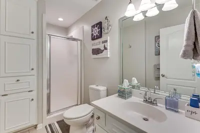 a bathroom with a toilet and a sink and a shower at Walk to Beach! PCB Resort Condo with Pool Access in Panama City Beach