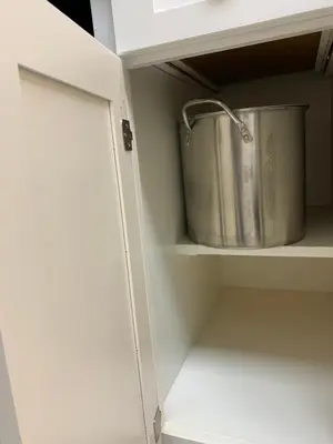 a pot on a shelf in a kitchen cabinet at Beach access close to Walmart, Bowling,skating and Game room in Panama City Beach