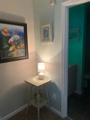 a lamp on a table in a room at Beach access close to Walmart, Bowling,skating and Game room in Panama City Beach
