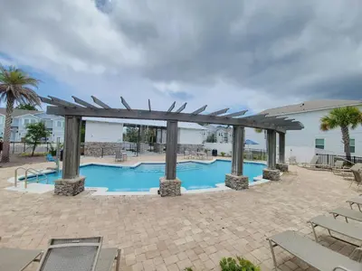 a swimming pool with a pergola next to a building at 7664 Shadow Lake - Happy Horizons - 3 Bedroom Sleeps 9 townhouse in Panama City Beach