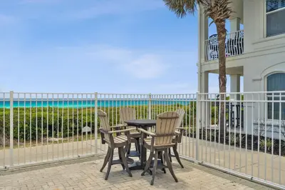 a table and chairs on the balcony of a house at 30A Villas at Sunset Beach by Panhandle Getaways in Rosemary Beach