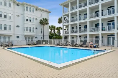 a swimming pool in front of a building at 30A Villas at Sunset Beach by Panhandle Getaways in Rosemary Beach