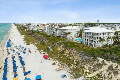 an aerial view of a beach with people and umbrellas at 30A Villas at Sunset Beach by Panhandle Getaways in Rosemary Beach