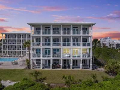 an exterior view of a large white building at 30A Villas at Sunset Beach by Panhandle Getaways in Rosemary Beach