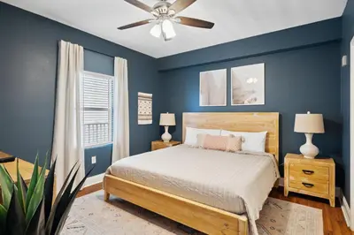 a blue bedroom with a bed and a ceiling fan at Laketown Wharf #333 by Nautical Properties in Panama City Beach